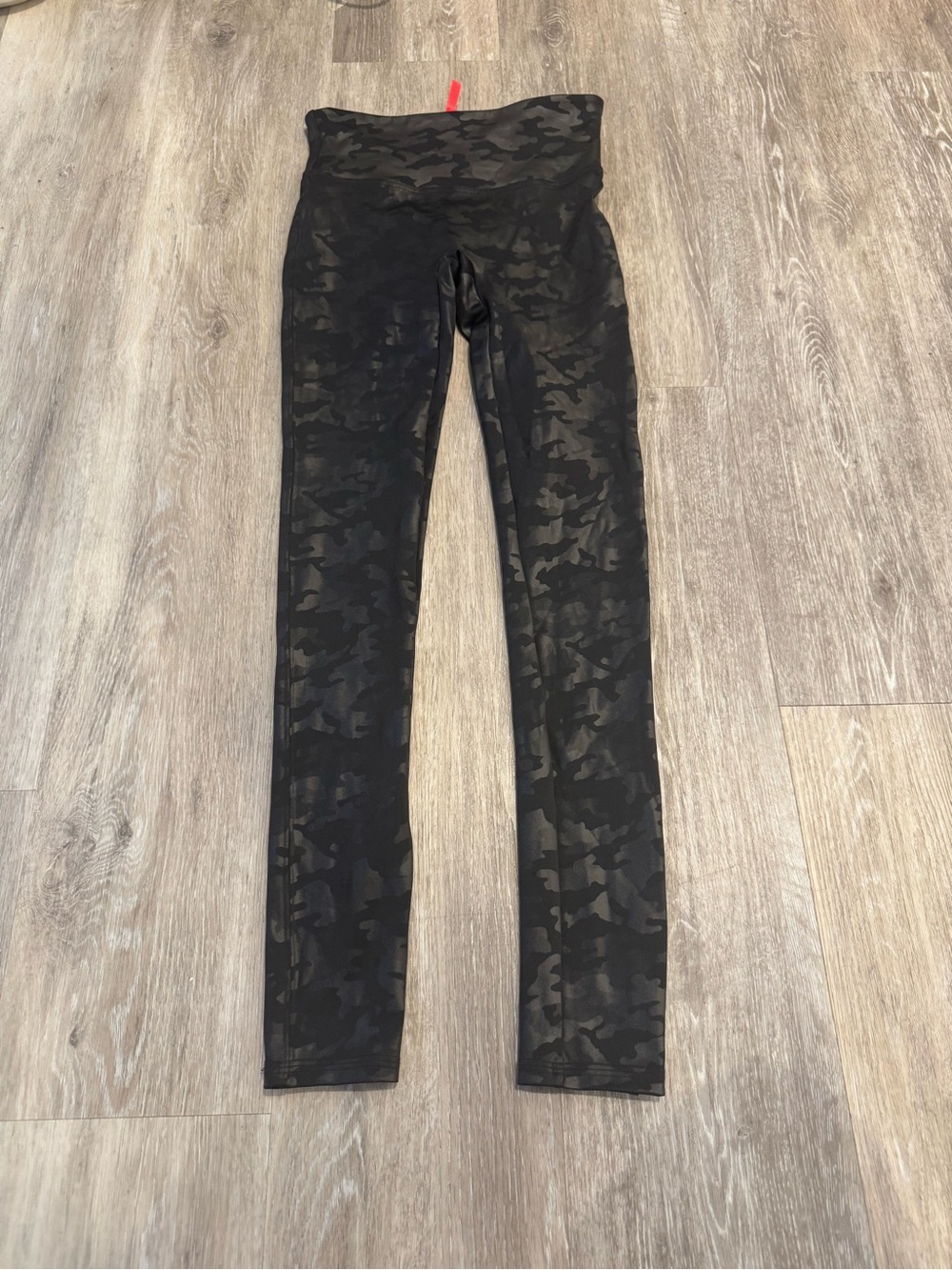 Spanx Faux Leather Camo Leggings in a matte black camouflage pattern